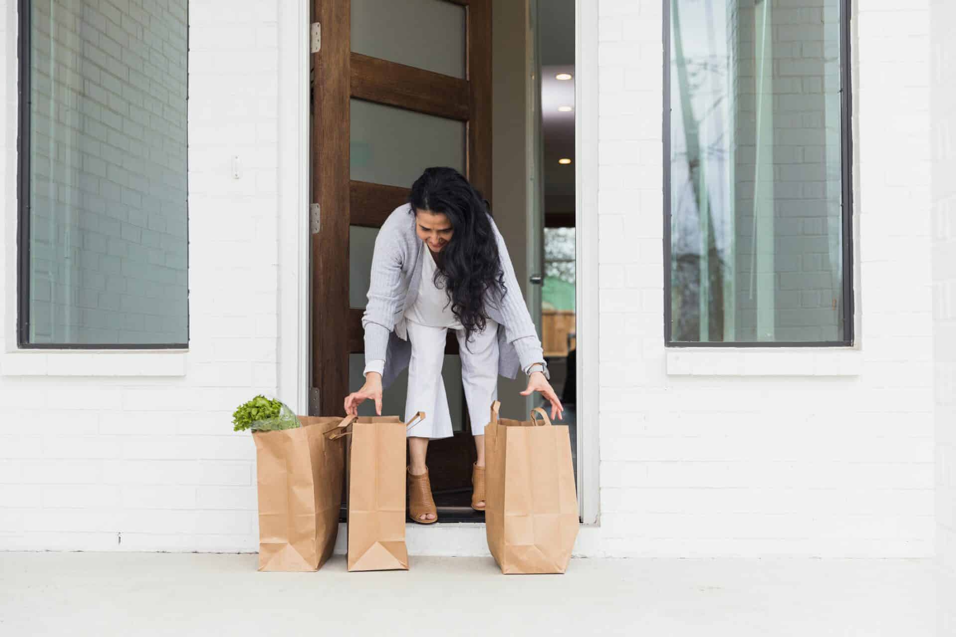 Woman steps out to pick up e-commerce grocery order