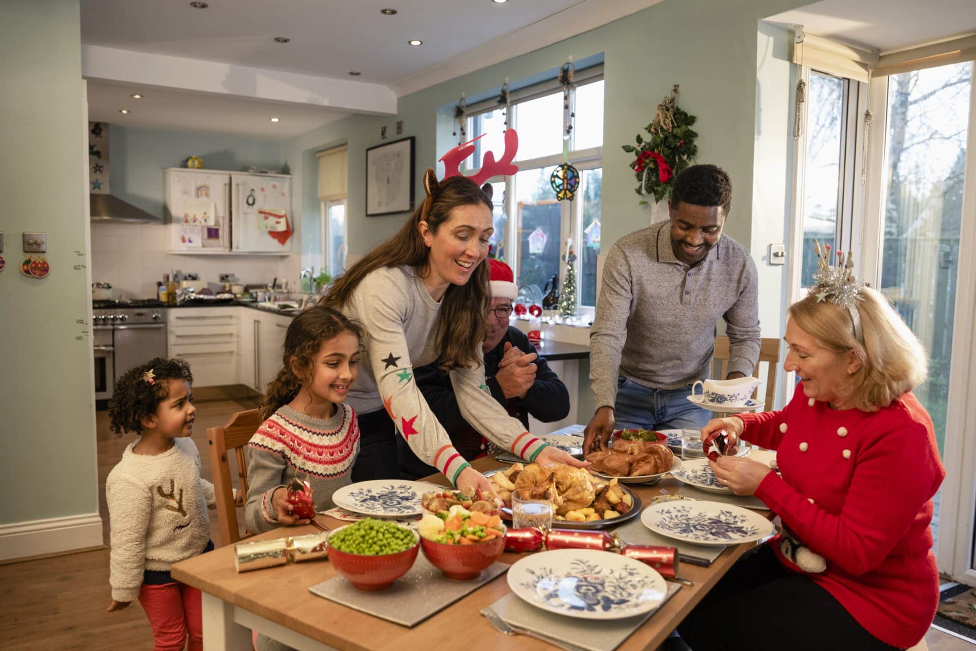 Front view of a family getting settled to have Christmas dinner