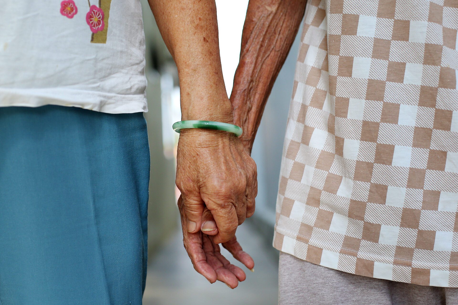 A senior couple holding hands